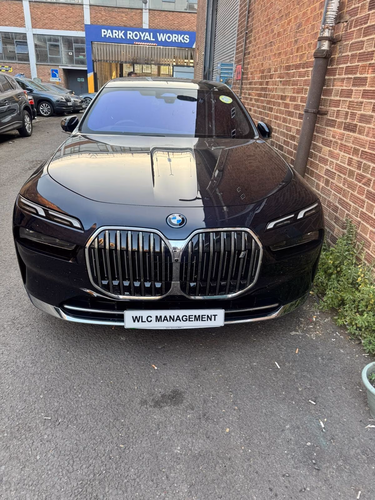 Black BMW 7 Series in the yard at Park Royal Works, front view