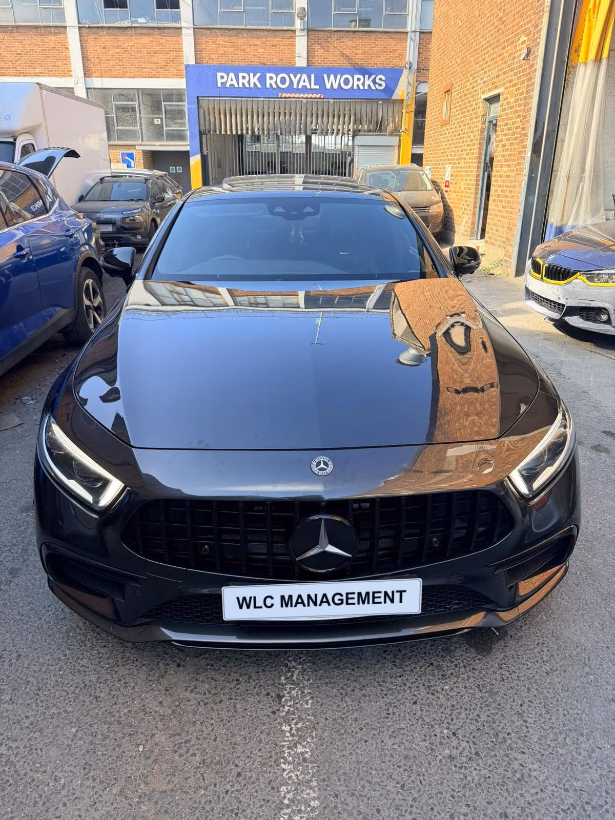 Black Mercedes-AMG CLA in front of Park Royal Works, front view